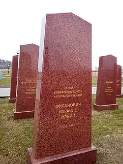 A cartoon centipede reads books and types on a laptop.