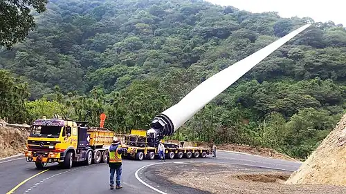 Mercedes-Benz SK Ballast Tractor pulling Goldhofer hydraulic modular trailer with FTV 300 blade lifter carrying a Windmill blade.