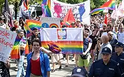 Bartosz Staszewski (left) carries a rainbow version of the flag of Poland at the 2018 Equality March in Częstochowa.