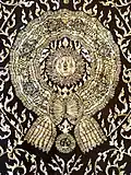 A mother-of-pearl inlay of "Maha Surabhorn", the Knight Grand Cross (First Class) of the Order of the Crown of Siam, version that was used from 1869 to 1909, at the gates of Phra Uposatha of Wat Ratchabophit Sathit Maha Simaram, Bangkok.