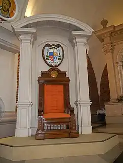 Cathedra, with the Cathedral/Bishop's Coat of arms (Ecclesiastical heraldry) above it