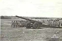 'T' Australian Heavy Battery at Fort Lytton with M1917/1918 155-millimetre (6.1&nbsp;in) heavy gun. Heads are bowed during a ceremony on Armistice Day 1943[gallery 19]