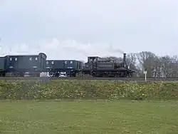 Fenchurch at the Bluebell Railway (April 2009) showing the intricate pipework along the boiler and the comparative size of the engine to the rolling stock, the wagons being slightly younger than the locomotive.