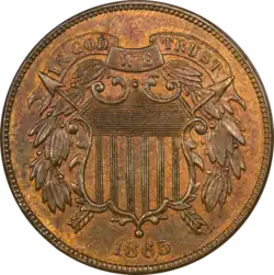 A bronze coin with a shield in the center, dated 1865.
