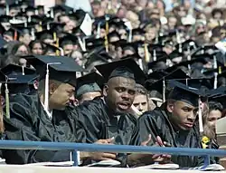 Three black men wearing full academic dresses