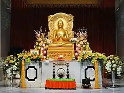 A replica of the Buddha Preaching his First Sermon sculpture, located in the modern Mulagandha Kuty Vihara