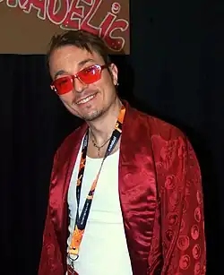 A man in a hoodie with sunglasses standing in front of toy shelves