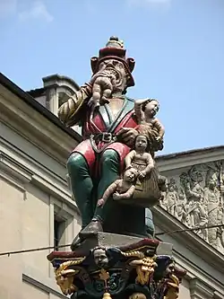 Ogre Fountain (lit. "Child Eater Fountain") at Corn House Square, Bern, Switzerland .