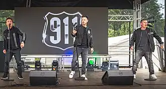 911 performing live at Durham Pride, May 2025 (L-R: Jimmy Constable, Lee Brennan and Spike Dawbarn).