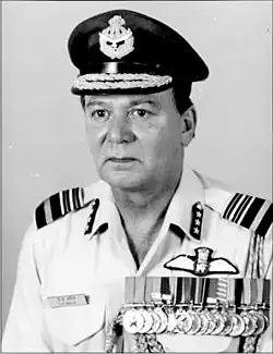 A black and white photograph of a middle aged man wearing his light blue air force uniform and medals