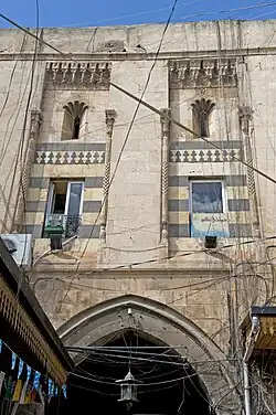 Interior façade of a gate from the courtyard of Khan al-Jumruk in Aleppo, Syria (1574)[2]