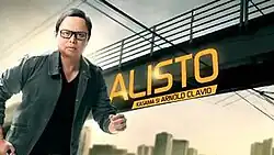An image of Arnold Clavio, with a bridge, buildings and wires on the background. The show title is displayed on the center of the image. The texts "Kasama si Arnold Clavio" are written below the show title.