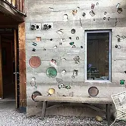 Concrete wall of ceramics studio outside a kiln yard.