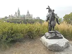 Anishinaabe Scout from rear, with the Parliament Hill in the background