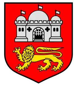 A shield with a red background. A white castle is in the top of the shield, while a yellow lion is on the bottom.