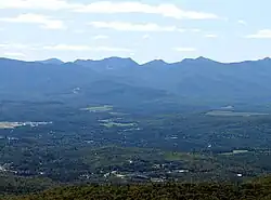 Lake Placid village, foreground, Armstrong Mountain and Gothics from McKenzie