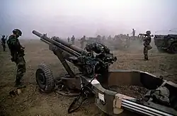 Artillerymen of the 82nd Airborne Division set up M-102 105mm howitzer in a field during NATO-sponsored Autumn Forge exercises