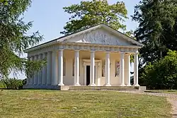 A colour photograph of a classical-style temple with a portico supported by Doric columns