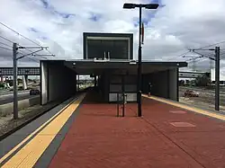 Brick island platform with steel shelter