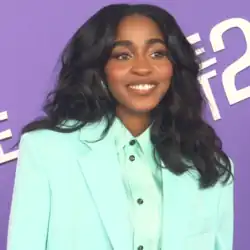 Edebiri holding a microphone