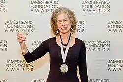 A photograph of Goldstein wearing a James Beard Medal