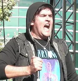 A man performing on stage holding a microphone