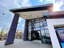 Photo of Bicester Village station, featuring a blue tiled atrium.