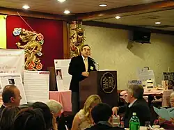 A man speaking to a crowd of people