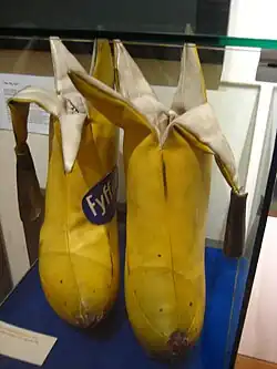 Two yellow bananas tailor-made in cloth with the tops peeled and the cloth skin hanging down.