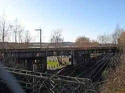 To the east of the station, the former railway line crosses over the North Clyde Line.