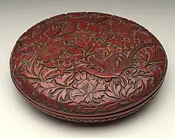 He (Box) with Pair of Pheasants in Peonies, late Ming, 19&nbsp;cm wide. Thin top layers of red over black give effective contrasts.