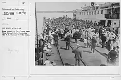 Boy Scouts crowd entire pier to board vessel