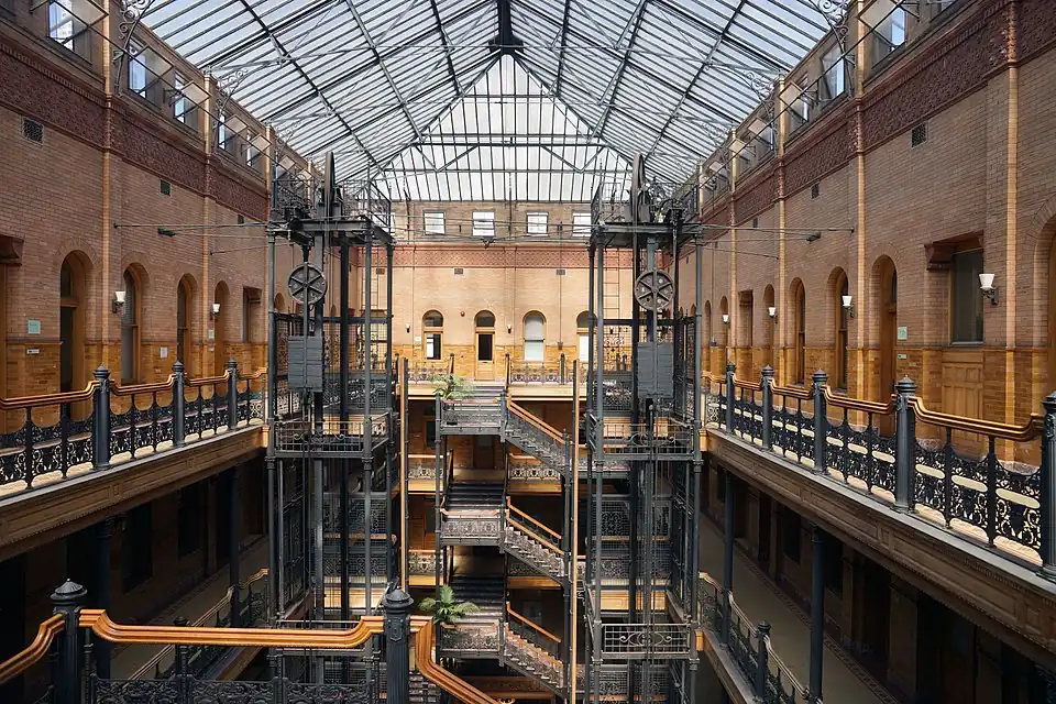 Interior of the Bradbury Building, with its exposed staircases and free-standing hydraulic elevators, Los Angeles, USA, by George Herbert Wyman, 1889-1893[249]