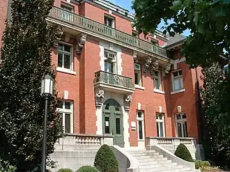 Ornate upper bronze balustrade, lower vasiform stone balustrade, and bronze central rail supported by decorative bronze metalwork at Brown University's Orwig Music Library