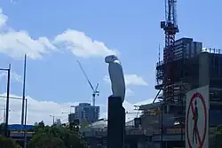 A large sculpture of an eagle with a roadway in front
