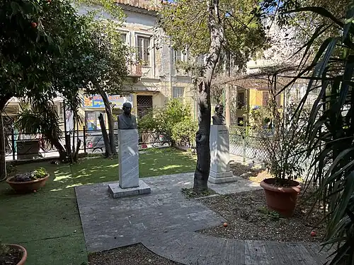 Two busts in a city garden
