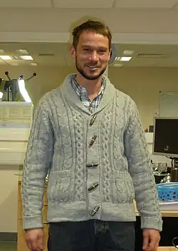 Man wearing shawl collar cardigan and hipster-inspired beard, 2011.
