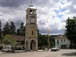 The central square in Chuprene with the clock tower, the church and the school