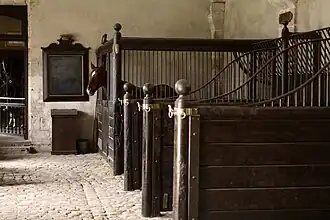 Typical early stable with a row of tie stalls and one box stall