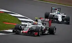 Leclerc driving the Haas VF-16 in free practice at the 2016 British Grand Prix, ahead of Felipe Massa