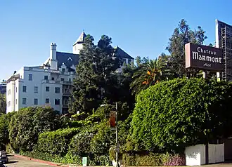 View of the Chateau Marmont hotel building from Sunset Boulevard, showing a multi-story French château-style structure