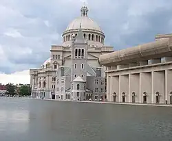 domed stone building alongside a canal or river