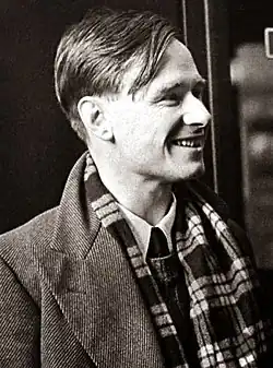A black and white photograph of gay author Christopher Isherwood at a train station