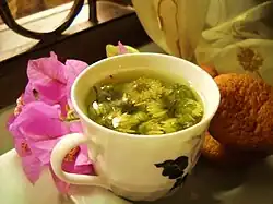 Chrysanthemum blossoms steep in a cup of hot water