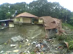 Destruction of classroom buildings along the bankside of a waterway