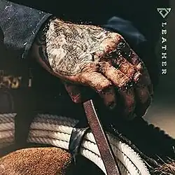 A photo of Johnson's tattooed and dirty hand