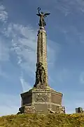 The war memorial at Aberystwyth seafront. The bottom figure represents Humanity and the top Victory