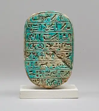 The back of a commemorative scarab of Amenhotep&nbsp;III, recording a lion hunt; 1390–1352&nbsp;BC; blue glazed steatite; length: 8&nbsp;cm; Metropolitan Museum of Art