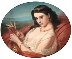 A young beauty reclining draped in a dress