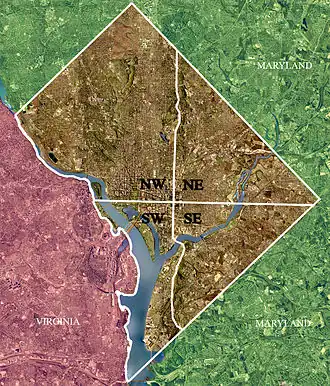 Color-enhanced 2002 USGS satellite image of Washington, D.C. The crosshairs in the image mark the quadrant divisions of Washington, D.C., with the United States Capitol at the center of the dividing lines. To the west of the Capitol is the National Mall, which is visible as a slight green band in the image. The Northwest quadrant is the largest, located north of the National Mall and west of North Capitol Street.